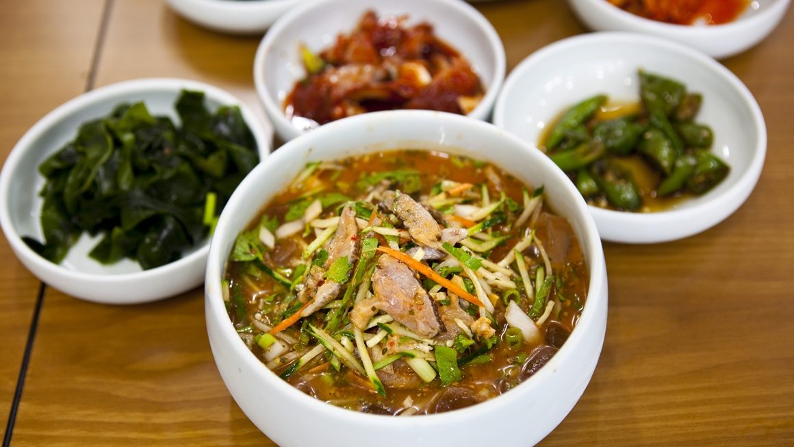 a bowl of soup with vegetables and meat